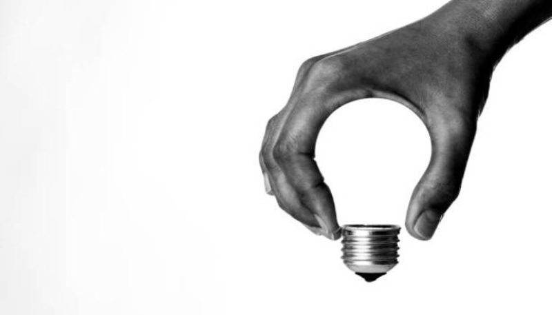 Light bulb in human hand, b&w.